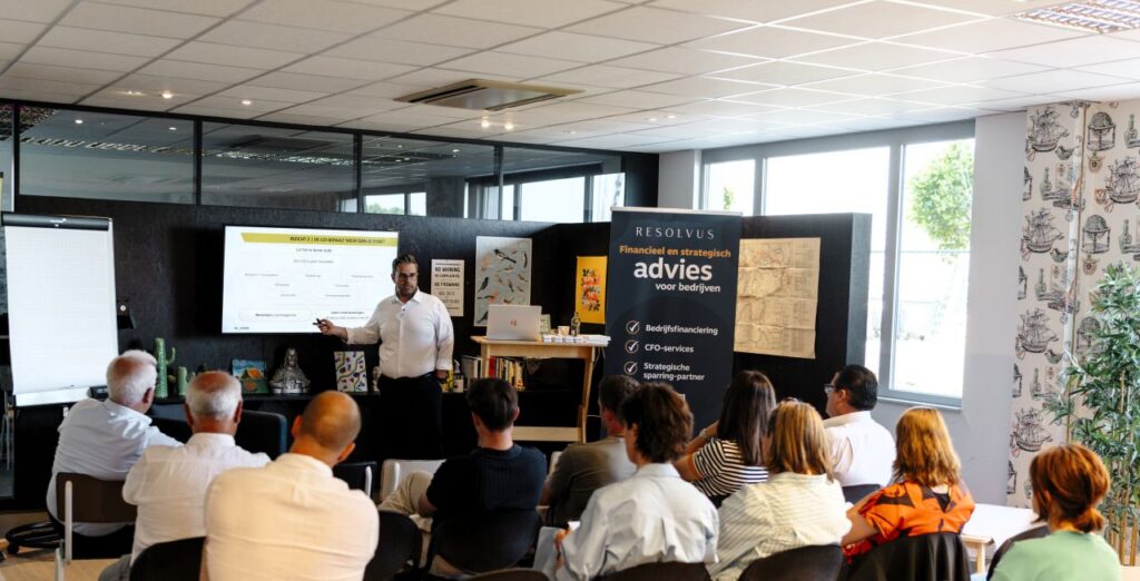 Nuans partner presenting M&A workshop at Resolvus inspiring Network Day, with audience seated and Resolvus financial advisory